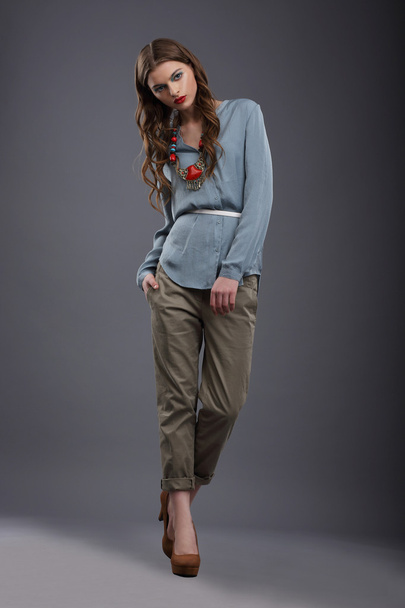 Studio Shot of Trendy Fashion Model in Pants and Blouse - Фото, зображення