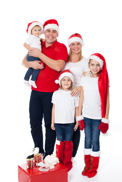 Happy cute family in santa's hats - Фото, изображение