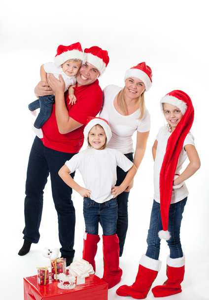 Happy cute family in santa's hats - Foto, Imagen
