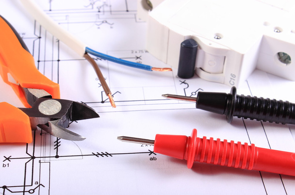 Cables of multimeter, pliers, electric fuse and wire on construction drawing - Photo, Image