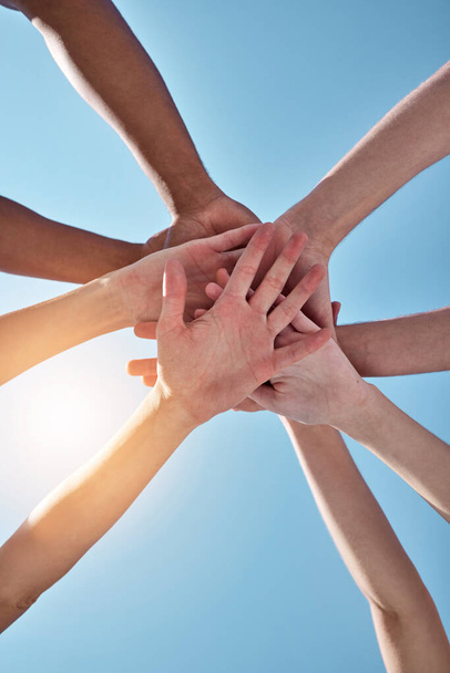 Well always be on the same team. a group of unrecognizable people stacking their hands - Foto, Imagem