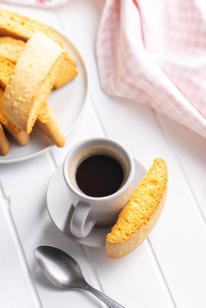 Sweet anicini cookies and coffee cup. Italian biscotti with anise flavor on a white table. - Foto, immagini