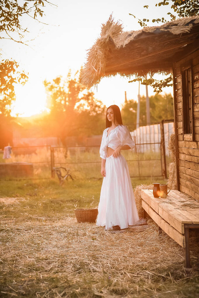 beautiful young woman in a white dress in the park - Photo, Image