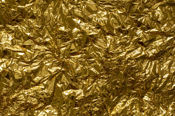 Zerknüllte goldene Gewebe Nahaufnahme Hintergrund Vollbild - Foto, Bild