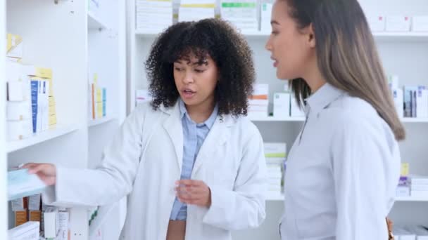 Friendly pharmacist explaining dosage instructions to woman in a drugstore. Healthcare worker offering good service and expert advice to customer by recommending and dispensing medicine from a shelf. - Filmagem, Vídeo