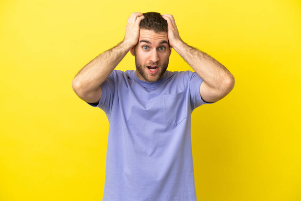 Handsome blonde man over isolated yellow background doing nervous gesture - 写真・画像