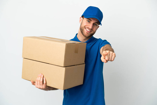 Delivery man over isolated white background pointing front with happy expression - Photo, Image