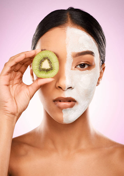 Healthy skin comes from within. Studio shot of an attractive young woman holding kiwi fruit to her face against a pink background - Fotó, kép