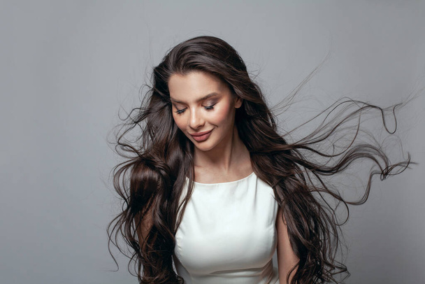 Perfect brunette woman, long healthy windy hair in motion - Foto, Imagen
