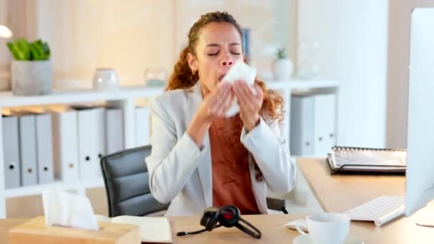 Female feeling unwell with flu, cold and covid symptoms. Congested with sinuses and spring allergies. Sick business woman sneezing and blowing her runny nose with a tissue while working in an office. - Кадры, видео
