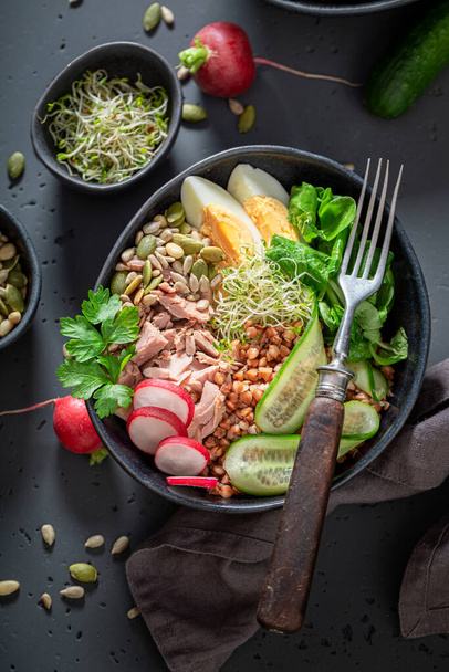 Healthy Nicoise salad with cucumber, tuna and eggs. Healthy bowls on a diet. - Fotografie, Obrázek
