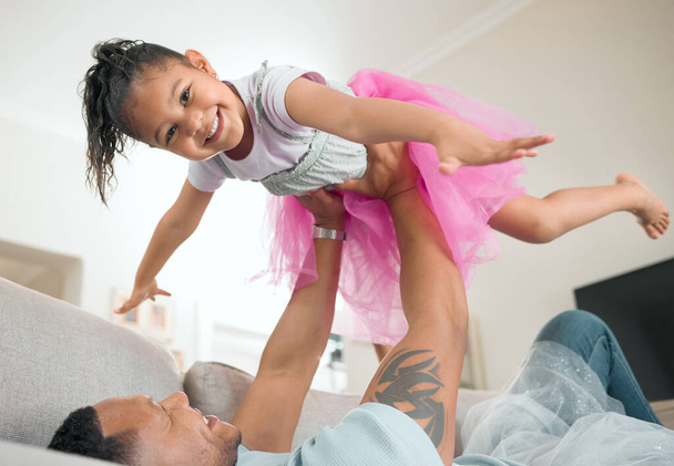 My dad is the wind beneath my wings. an adorable little girl bonding with her father in the living room at home - Фото, изображение