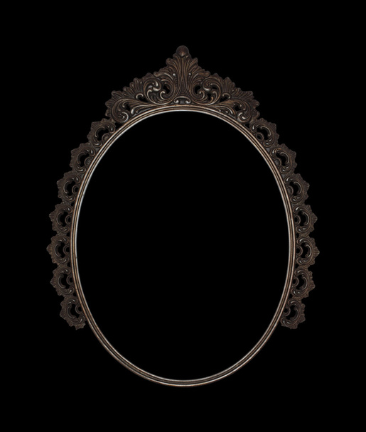 Old oval picture frame metal worked on black background - Photo, Image