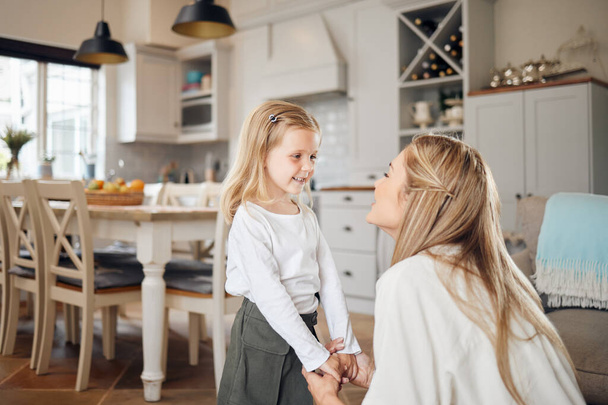 The strength of a family, like the strength of an army. a mother and daughter talking at home - Valokuva, kuva