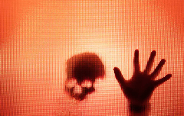 Horror ghost figure behind the matte glass. Halloween festival concept. - Photo, Image