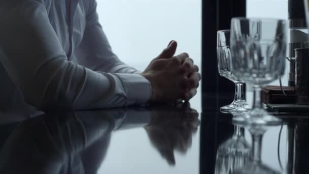 Closeup male hands folding together on served cafe glass table. Unrecognizable man thinking or making decision. Unknown entrepreneur concentrating at important negotiations. Business concept. - Imágenes, Vídeo