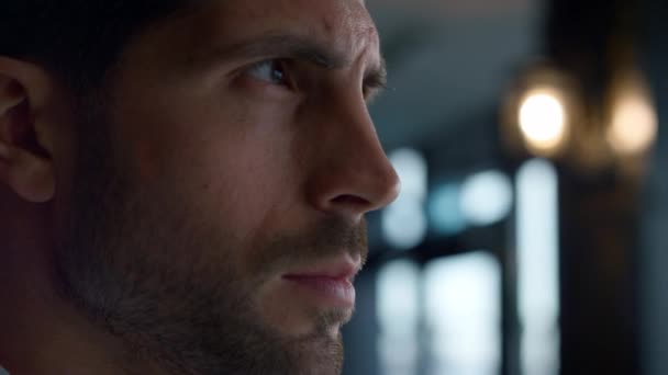 Charismatic man spending time in lounge cafe profile. Closeup thoughtful businessman looking away in dark hotel bar interior. Contemplating male face expression close up. Serious decision concept. - Imágenes, Vídeo