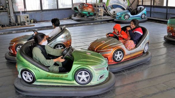 Ooty,Tamilnadu,India-April 30 2022: Young children enjoying adventurous fun dashing car inside the kids park of Ooty boat house. - Photo, image