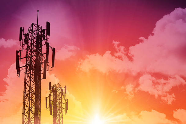 5G Communication tower or 4G network telephone cellsite silhouette on sunny colorful sky background. - Photo, Image