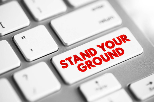 Stand Your Ground text button on keyboard, concept background - 写真・画像