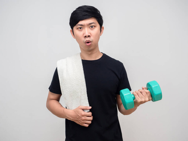 Young man workout with dumbbell feels tried isolated - Photo, image