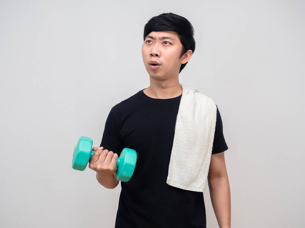 Asian man workout with dumbbell feels tried isolated - Foto, afbeelding