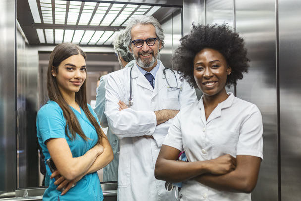 Medical staff people group. Team of doctor and nurse in hospital elevator. Healthcare and medicine concept. Team of Female and Male Doctors or Nurses - 写真・画像