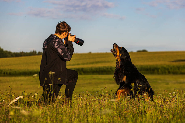 boy and hovie, two friends, dog barking at camera lens - Fotoğraf, Görsel