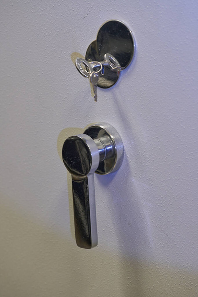 Lock and key on the door of a safe. High quality photo - Zdjęcie, obraz