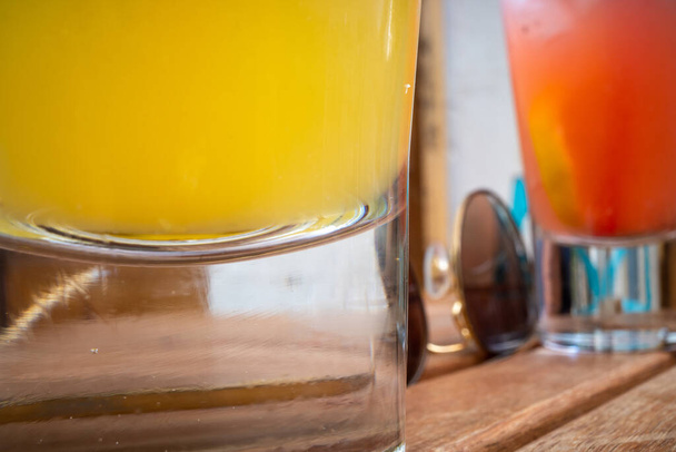 Gjirokaster, Albania Exotic drinks on a wooden bar table outdoors. - Фото, зображення