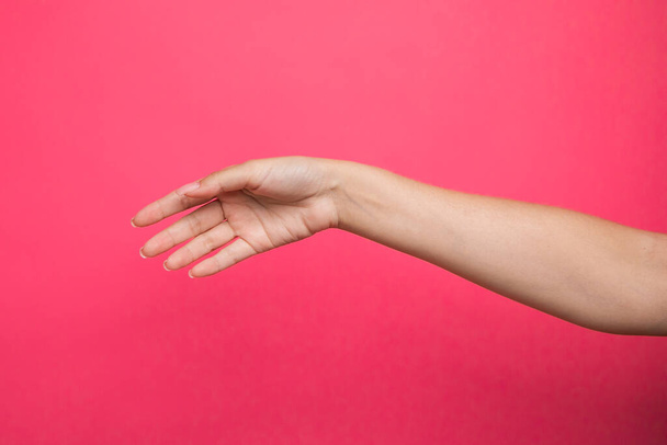 Female hand up on pink background. High quality photo - Foto, imagen
