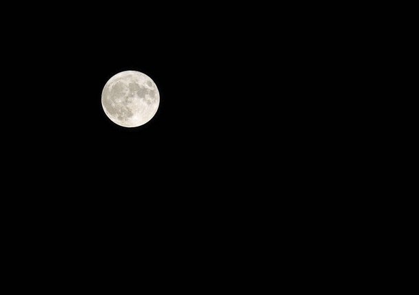 яскравий великий повний місяць, і ви також бачите багато кратерів з тлом чорного неба опівночі
 - Фото, зображення