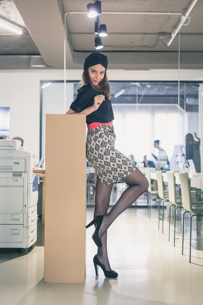 Beautiful young brunette posing in an office - Фото, изображение