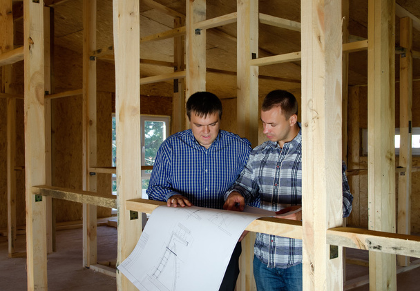 Two builders in a new build house - Photo, Image