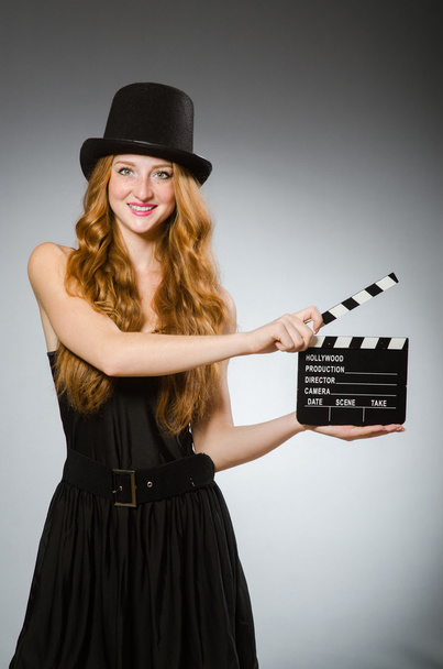 Woman with movie board wearing hat - Zdjęcie, obraz