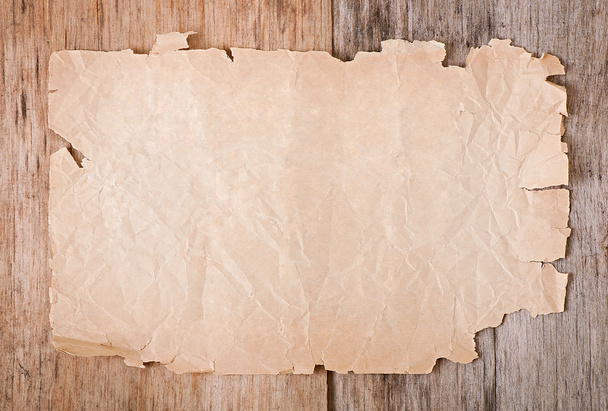Old paper on old wooden background - Фото, изображение