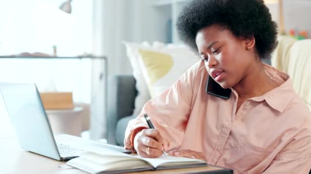 Female student talking on a phone call while typing an academic essay or doing a homework assignment alone at home. Young university or college student with afro getting help with drafting an email. - Video