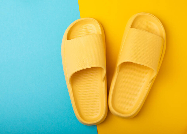 Stylish rubber slippers on a blue background.Replacement shoes.Beach shoes.Copy space. Place for text. - Fotografie, Obrázek