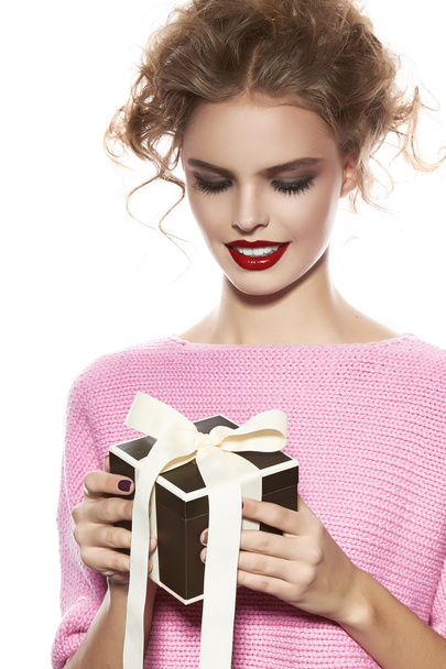 Beautiful woman with evening make-up takes box with present - 写真・画像