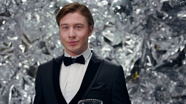 Young Man On Shiny Background With Glasses Of Champagne. Cute Man In Suits. Party. - Фото, изображение