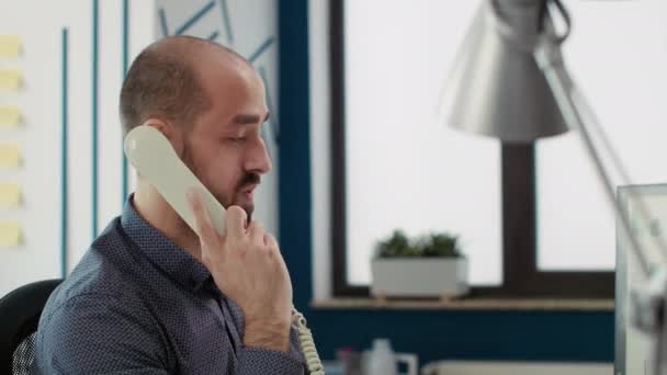 Company secretary talking on landline phone call with manager, consulting leader about project development. Financial analyst having remote conversation on office telephone line at job. - Záběry, video