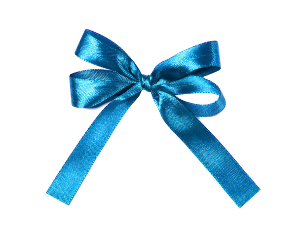 Синий (лазурный) ткань лента и лук изолированы на белом фоне
 - Фото, изображение