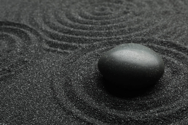 Black sand with stone and beautiful pattern. Zen concept - Fotoğraf, Görsel