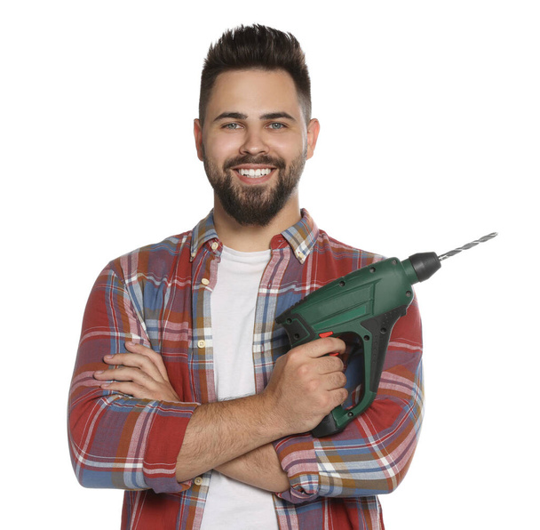Young man with power drill on white background - Zdjęcie, obraz
