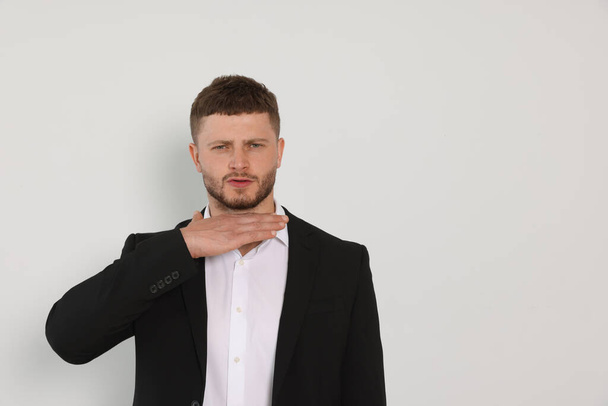 Aggressive young man on white background, space for text - Fotografie, Obrázek