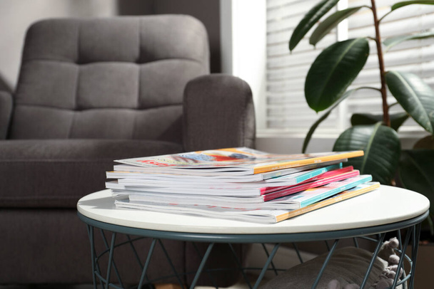 Many stacked magazines on table in room - Photo, image