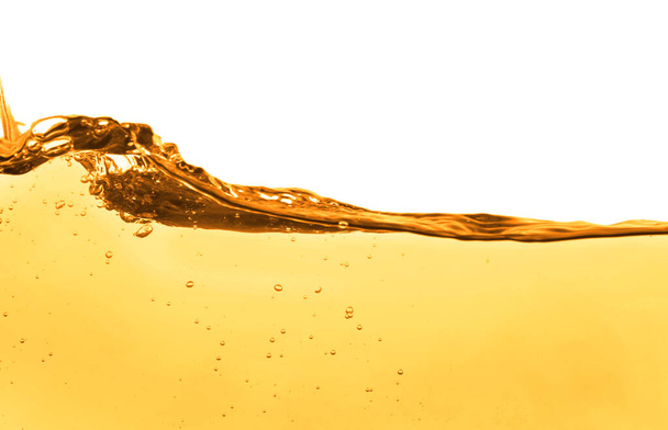 Golden oily liquid splash on white background - Foto, afbeelding