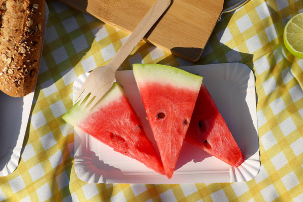 Delicious watermelon and bread on picnic blanket, flat lay - Fotoğraf, Görsel