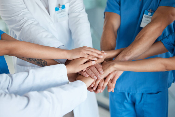 Together were going to change the world. a team of medical staff with their hands stacked - 写真・画像