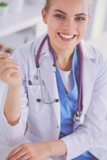 Close up Portrait of friendly female doctor with stethoscope and tablet in hands - Foto, immagini